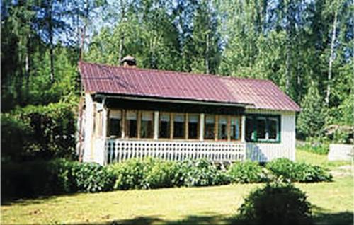a small white house with a red roof at Beautiful Home In Arvika With 2 Bedrooms in Vik
