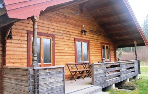 a log cabin with a porch and a bench at 4 Bedroom Lovely Home In Åsensbruk in Annolfsbyn