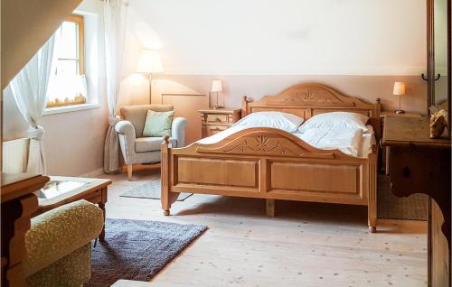 a bedroom with a wooden bed and a chair at Großes Ferienhaus Muerzsteg in Mürzsteg
