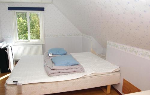 a bed with towels on it in a room at Nice Home In Olofström With Sauna in Olofström