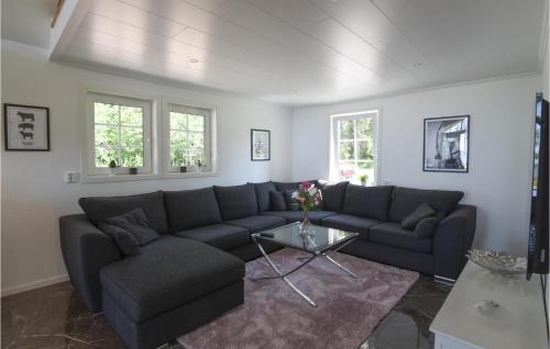 a living room with a couch and a table at Nice Home In Sjötorp With Kitchen in Sjötorp