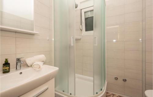 ein weißes Bad mit einer Dusche und einem Waschbecken in der Unterkunft 1 Bedroom Gorgeous Apartment In Drvenik in Drvenik