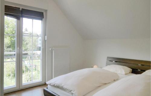 a bedroom with two beds and a large window at 1 Bedroom Pet Friendly Apartment In Wallendorf-pont in Wallendorf pont