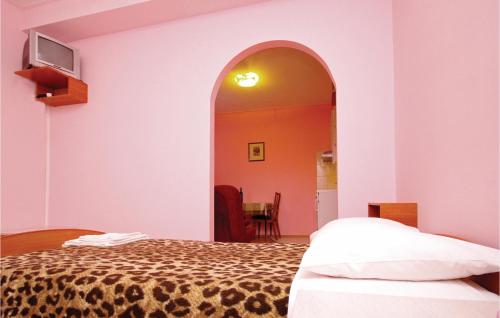 a bedroom with a bed and an arched doorway at 1 Bedroom Nice Apartment In Kastel Sucurac in Kaštela