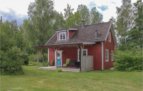 a red barn with a porch and a deck at Holiday Home C-O Jedhammar Holmsjö in Holmsjö