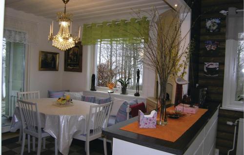 a kitchen and dining room with a table and chairs at 2 Bedroom Stunning Home In Unnaryd in Unnaryd