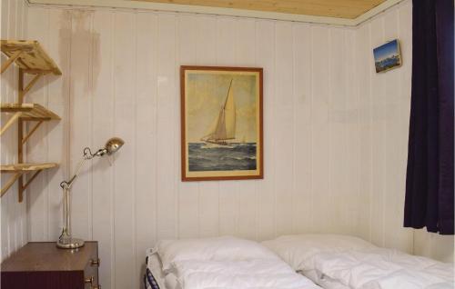a bedroom with two beds and a picture of a sailboat at Amazing Home In Staub With 1 Bedrooms And Wifi in Staubø