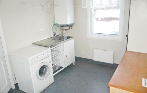 a laundry room with a washing machine and a sink at Cozy Home In Ölsremma With Wifi in Ljungsarp