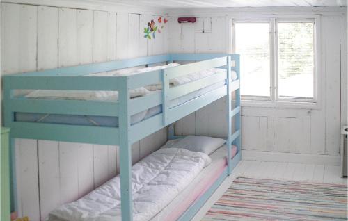 a bunk bed with four bunk beds in a room at 3 Bedroom Awesome Home In Mårdaklev in Mårdaklev