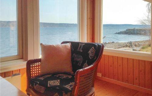 a chair with a pillow in a room with a window at 1 Bedroom Stunning Home In Sætre in Sætre