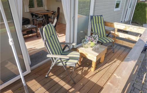 two chairs and a table on a porch at 2 Bedroom Stunning Home In Tzummarum in Tzummarum