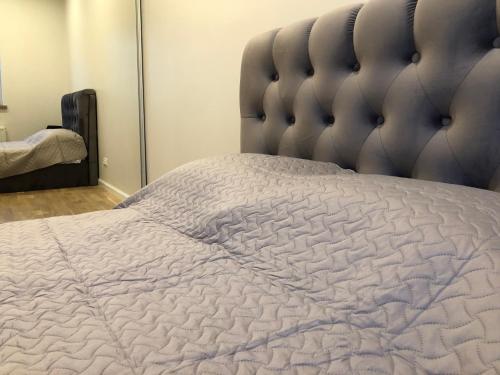 a bedroom with a large bed with a large headboard at Old Town Deluxe Apartment in Klaipėda