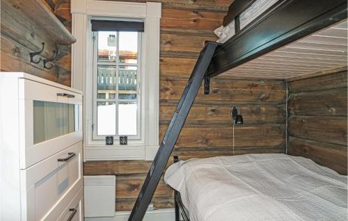 a bedroom with a bunk bed in a wooden wall at Sjusjen Setegrend 4733 in Sjusjøen