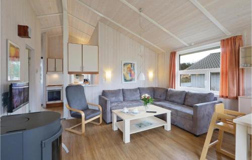 a living room with a couch and a table at Abendrot 2 - Dorf 3 in Priwall