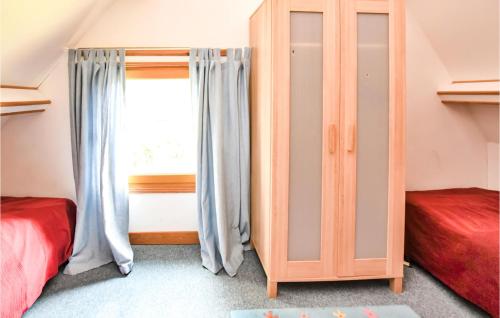 a bedroom with two beds and a window at Amazing Home In St Pierre En Auge in Vieux-Pont-En-Auge
