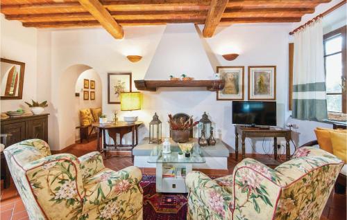 a living room with two chairs and a table at Piazzale 1 in Castellina in Chianti