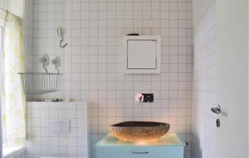 a bathroom with a sink in a tiled wall at Beautiful Home In Skty With House A Panoramic View 