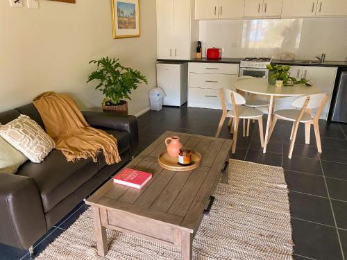 a living room with a couch and a table at Peacehaven Chalet on the Irwin Inlet in Bow Bridge