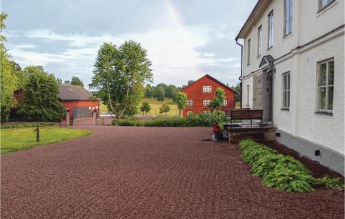 a building with a bench next to a brick driveway at Nice Home In Mantorp With Wifi in Mantorp