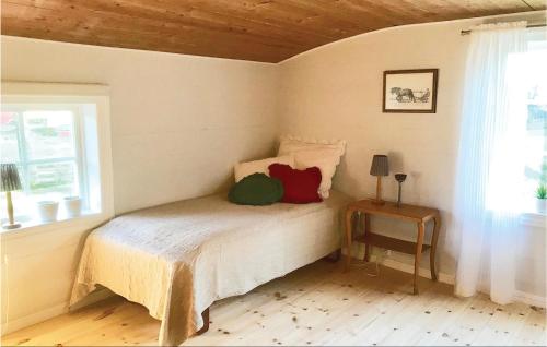 a bedroom with a bed and a window and a table at Amazing home in Unnaryd with 2 Bedrooms, Sauna and WiFi in Unnaryd