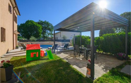 a patio with a canopy with a table and chairs at Holiday Home Dobrani Cr in Rebići