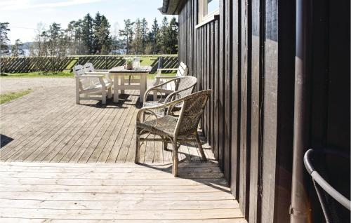 a patio with two chairs and a table on a building at Lovely Home In Enebakk With Wifi in Omberg