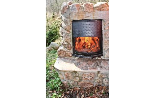 a fireplace made out of a stone at 2 Bedroom Beautiful Home In Örkelljunga in Drakabygget