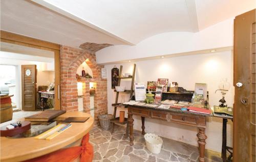 a room with a table and a brick wall at Ferienwohnung Eisenberg in Eisenberg an der Pinka
