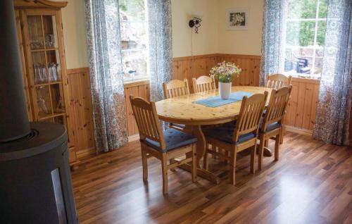 a dining room with a wooden table and chairs at Nice Home In Fjällbacka With Sauna in Fjällbacka