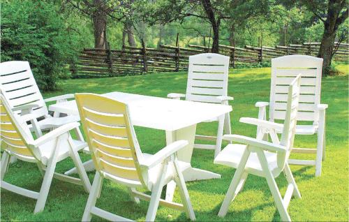 a group of white chairs around a white table at Gorgeous Home In Sävsjö With Wifi in Bodafors