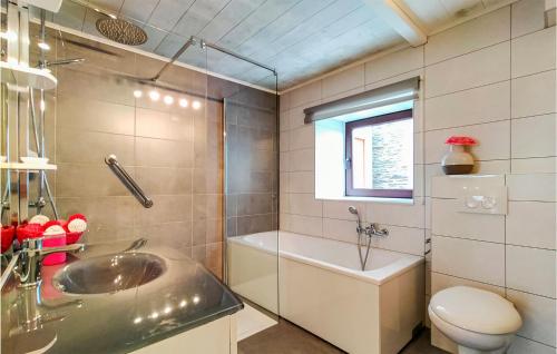 a bathroom with a sink and a toilet and a window at Nadrin O Vert in Nadrin