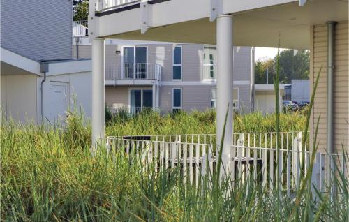 a porch with chairs in the grass in front of a house at Dünenvilla 9, Whg 2 in Travemünde
