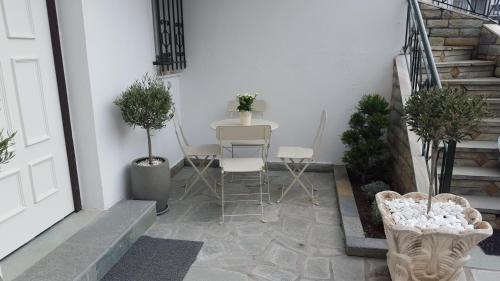 a patio with a table and chairs and stairs at ELIA COZY HOUSE in Paleo Tsifliki
