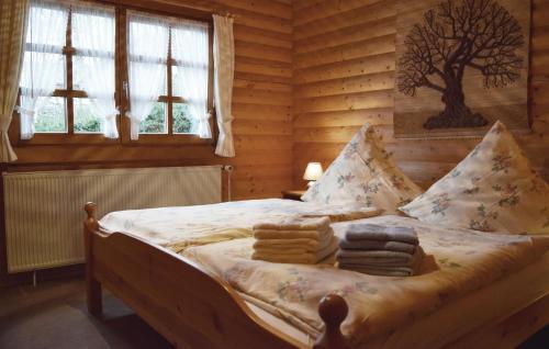 a bedroom with a bed in a log cabin at Lovely Home In Bodenfelde With Kitchen in Amelith
