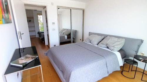 a bedroom with a large bed and a mirror at PORTO BLUE LUXURY APARTMENT in Porto Rafti