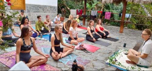 a group of people sitting on the ground at Eco Hacienda Roman in Machu Picchu