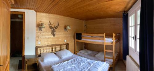 a bedroom with two bunk beds and a bed at la grange in Formiguères