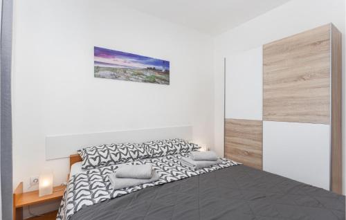 a white bedroom with a large bed with two pillows at Awesome Apartment In Viskovo With Kitchen in Viskovo
