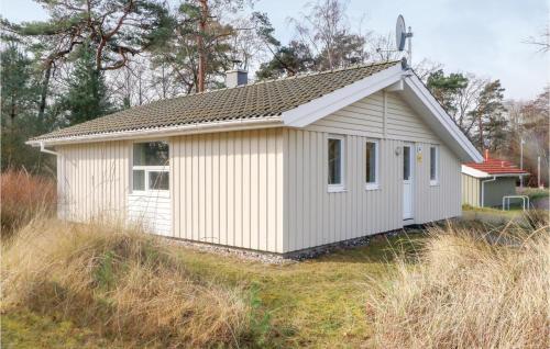a small white building sitting on top of a field at Dünenpark 16 - Dorf 6 in Priwall