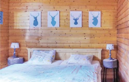 1 dormitorio con 1 cama y algunas fotos en la pared en Awesome Home In Schlindermanderscheid With 2 Bedrooms And Wifi, en Schlindermanderscheid