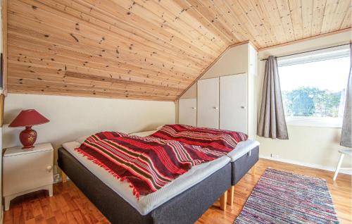 a bedroom with a bed with a wooden ceiling at Awesome Home In Fjrtoft With 5 Bedrooms, Internet And Sauna in Fjørtoft