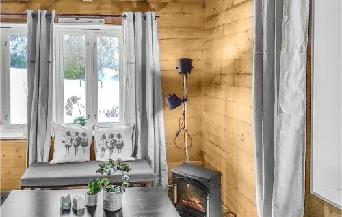 a living room with a chair and a fireplace at 3 Bedroom Lovely Home In Vikanes in Eikemo