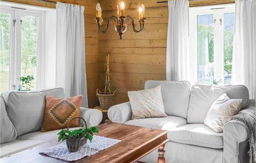 a living room with a couch and a table at 3 Bedroom Lovely Home In Vikanes in Eikemo