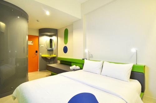 A bed or beds in a room at POP! Hotel Airport Jakarta