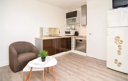 une petite cuisine avec une chaise et une table dans l'établissement Stunning Apartment In Sète With Wifi, à Mèze