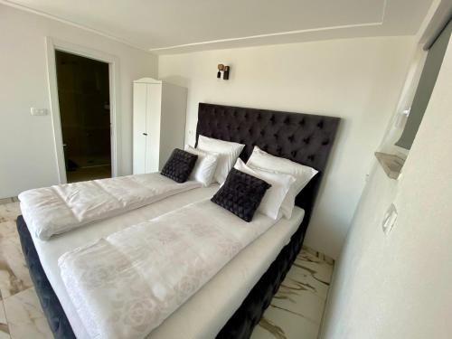 a bedroom with two beds with white sheets and pillows at Apartma Hill Portorose in Portorož
