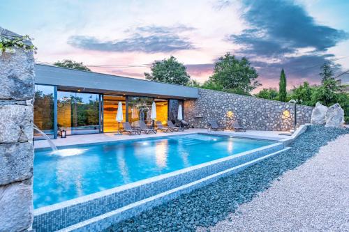 a swimming pool in the backyard of a house at Luxury Jerini Estate in Krk