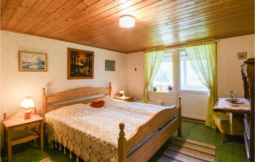 a bedroom with a bed and a wooden ceiling at Awesome Home In Ölsremma With Sauna in Ölsremma