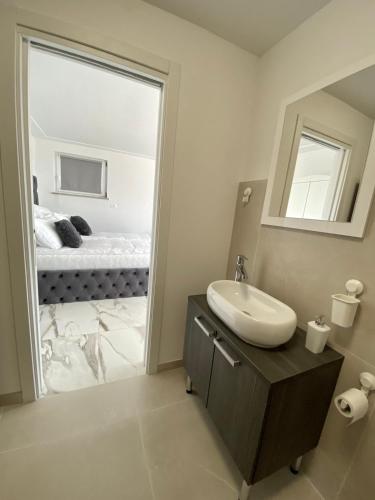 a bathroom with a sink and a mirror at Apartma Hill Portorose in Portorož