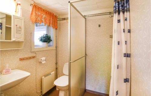 a bathroom with a shower and a toilet and a sink at Awesome Home In Ölsremma With Sauna in Ölsremma